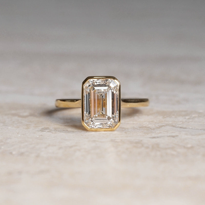 Ellie, IGI 3.08ct Emerald Cut Lab Diamond, 18K Yellow Gold Bezel Solitaire Ring