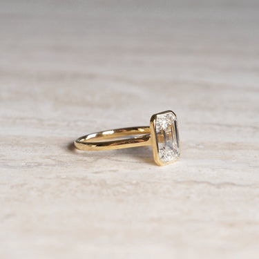 Ellie, IGI 3.08ct Emerald Cut Lab Diamond, 18K Yellow Gold Bezel Solitaire Ring