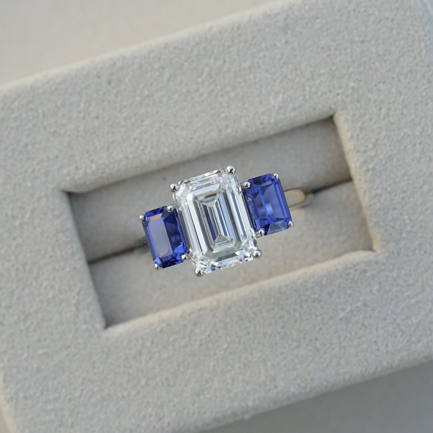 The Promise, IGI 3.09ct D VVS2 Emerald Cut Lab Diamond, PT950 Trilogy Ring with lab Sapphire Accents