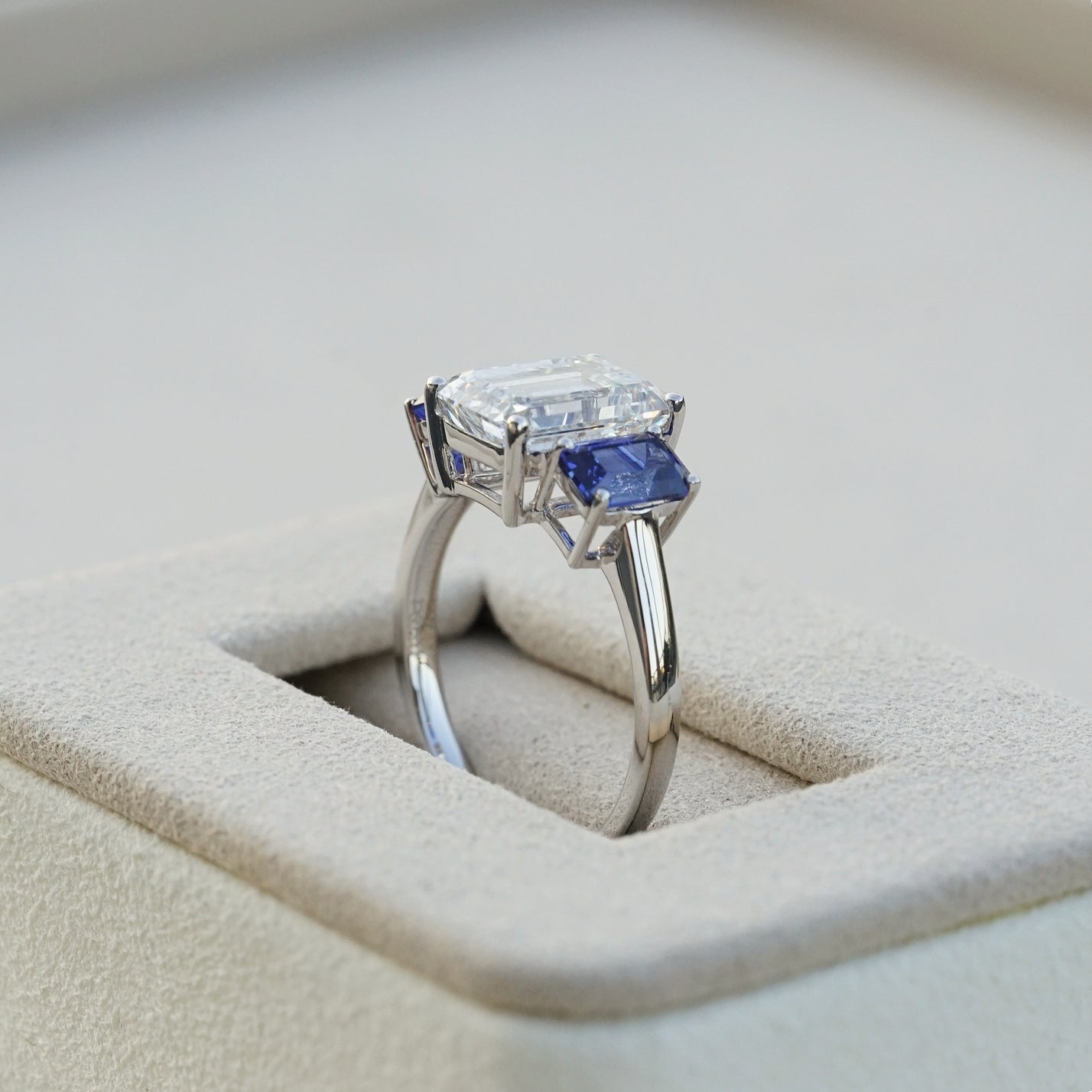 The Promise, IGI 3.09ct D VVS2 Emerald Cut Lab Diamond, PT950 Trilogy Ring with lab Sapphire Accents