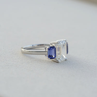 The Promise, IGI 3.09ct D VVS2 Emerald Cut Lab Diamond, PT950 Trilogy Ring with lab Sapphire Accents