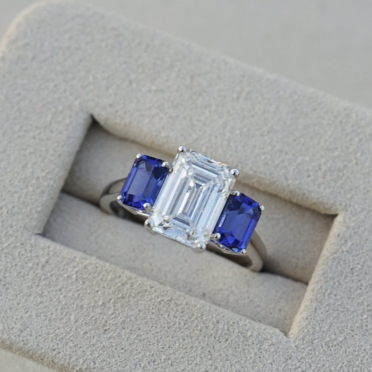The Promise, IGI 3.09ct D VVS2 Emerald Cut Lab Diamond, PT950 Trilogy Ring with lab Sapphire Accents