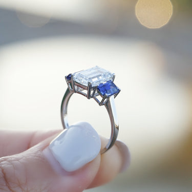 The Promise, IGI 3.09ct D VVS2 Emerald Cut Lab Diamond, PT950 Trilogy Ring with lab Sapphire Accents