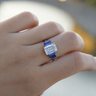 The Promise, IGI 3.09ct D VVS2 Emerald Cut Lab Diamond, PT950 Trilogy Ring with lab Sapphire Accents