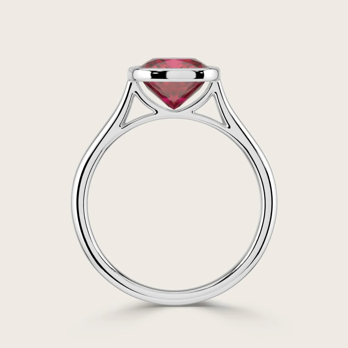 Cushion cut lab-grown ruby solitaire ring in 18k white gold, bezel set. "R25201CU" side view.