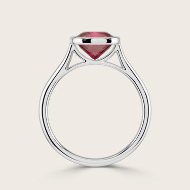 Cushion cut lab-grown ruby solitaire ring in 18k white gold, bezel set. "R25201CU" side view.