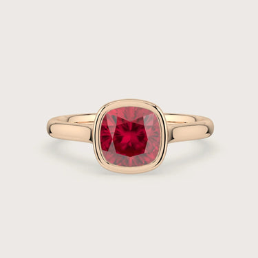 Lab-Grown Cushion Ruby Solitaire" bezel set in an 18k Rose Gold engagement ring.