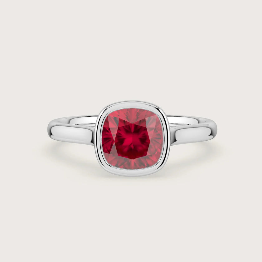Cushion" lab-grown ruby solitaire ring. 18k white gold bezel setting, elegant engagement ring.