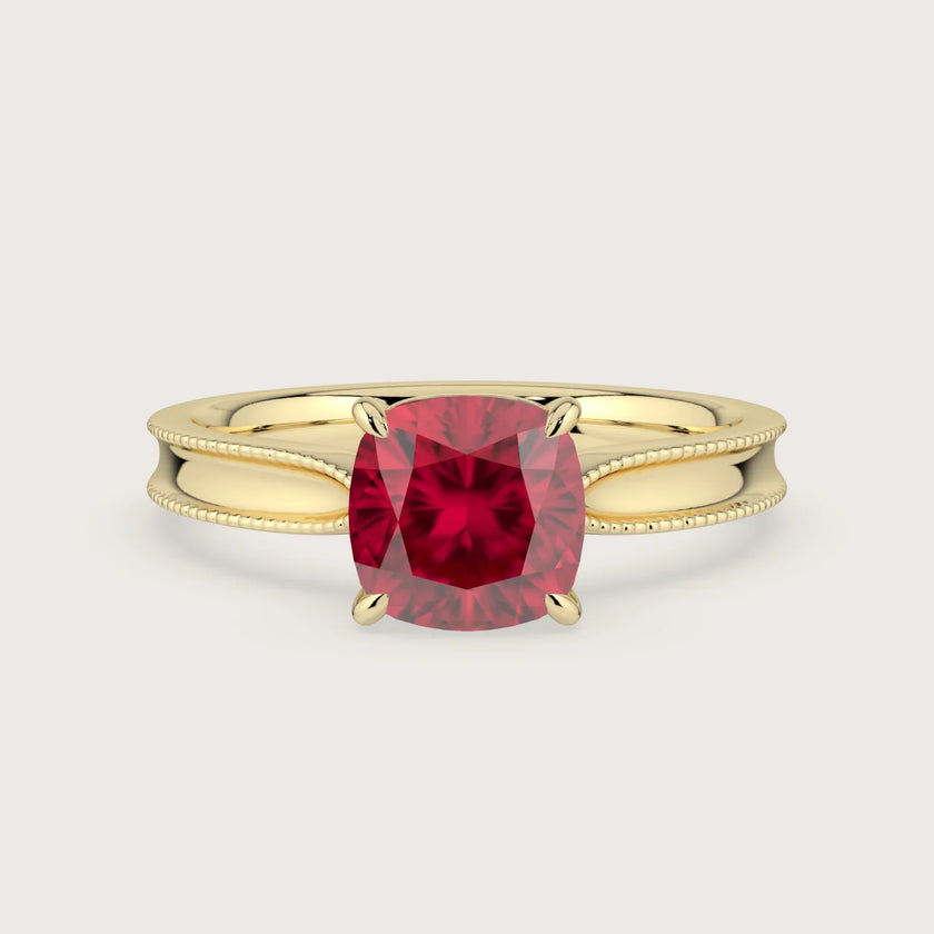 Cushion-cut lab-grown ruby solitaire engagement ring in 18k yellow gold with milgrain detailing. "R24821CU.