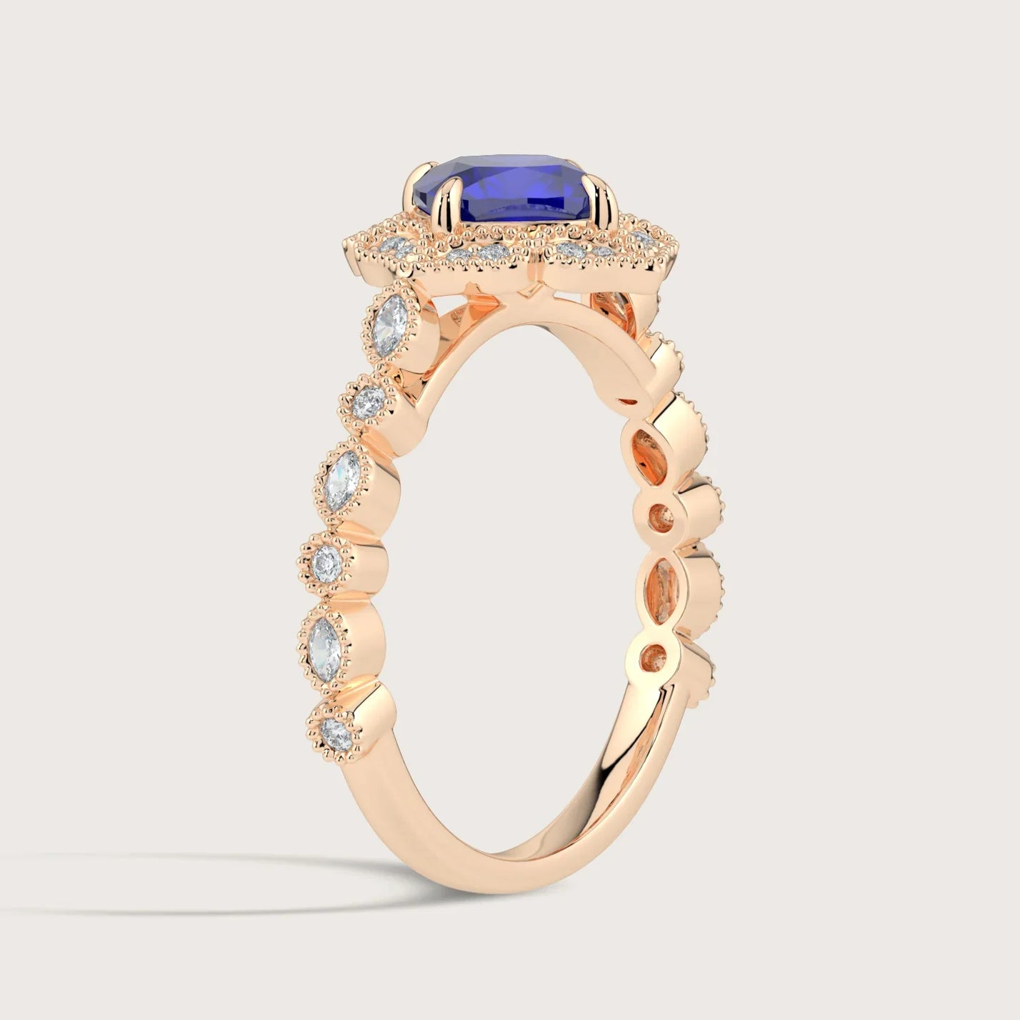Rose gold ring with cushion-cut lab-grown sapphire, diamond halo and band. "R25307CUHA" style.