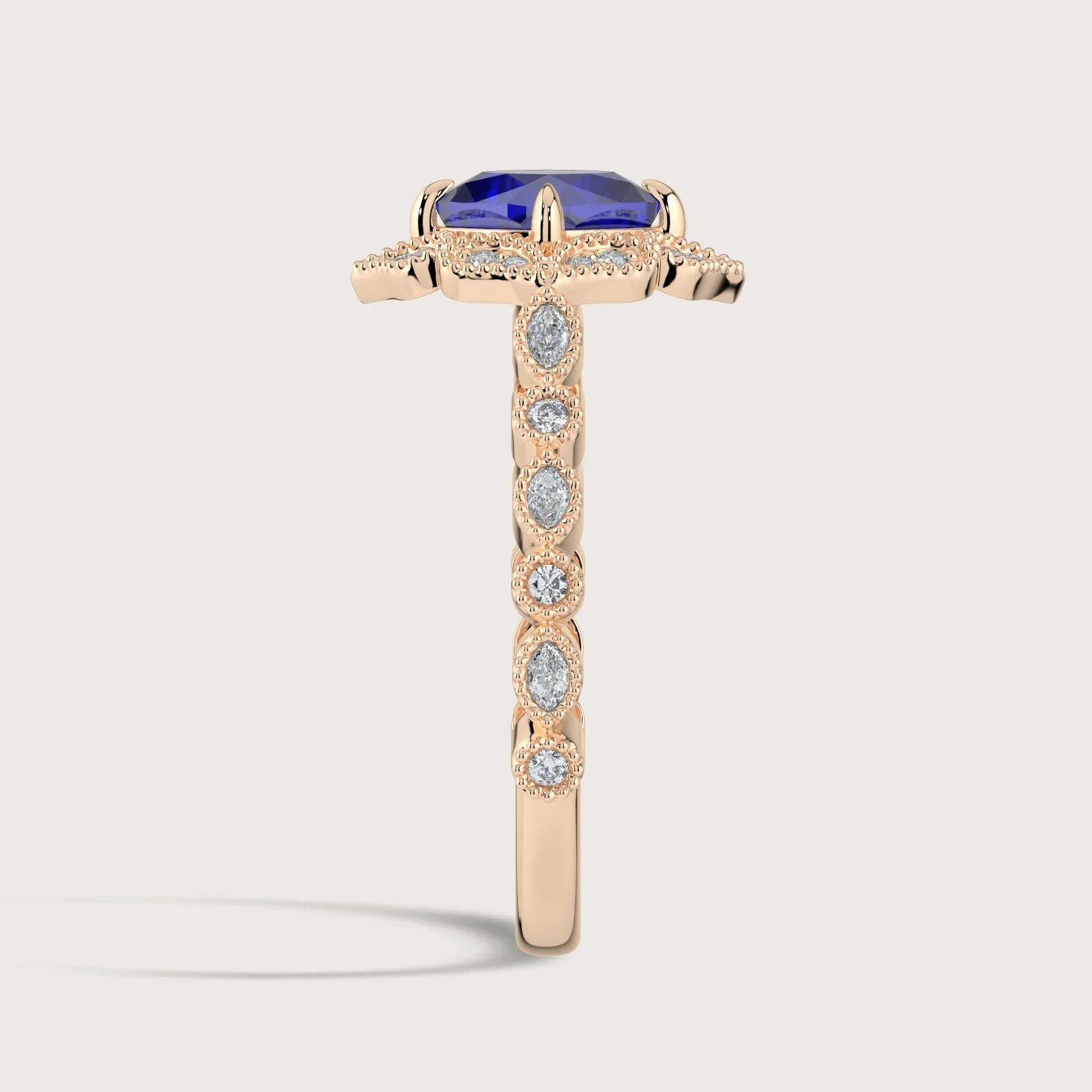 Rose gold "cushion" cut lab-grown sapphire ring with diamond halo and band.