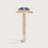 Rose gold "cushion" cut lab-grown sapphire ring with diamond halo and band.
