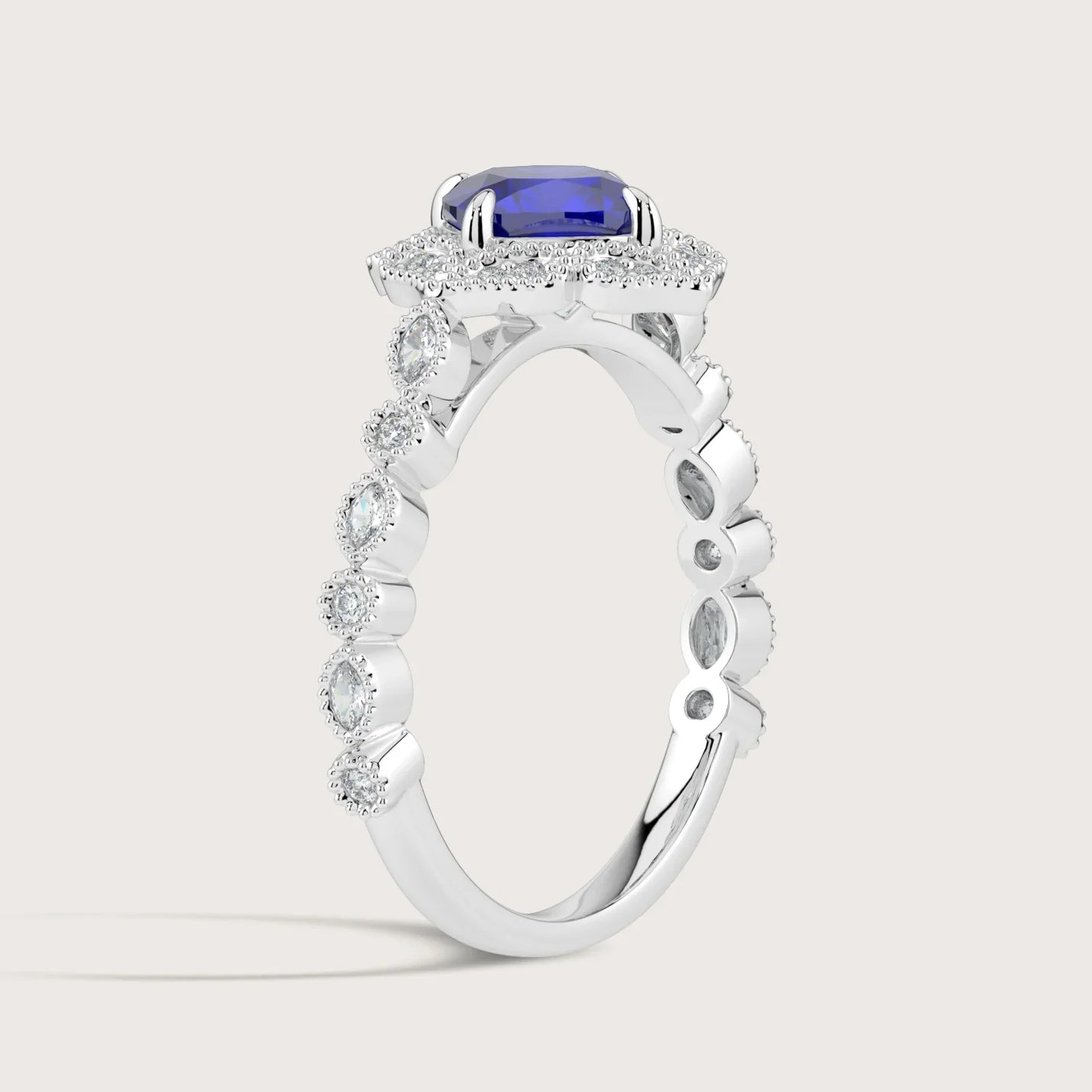 Lab-grown cushion sapphire ring in 18k white gold with diamond halo and band. "R25307CUHA" detail.