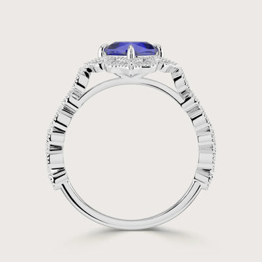 Side view of a "lab-grown cushion sapphire" ring with a diamond halo and band in 18k white gold.