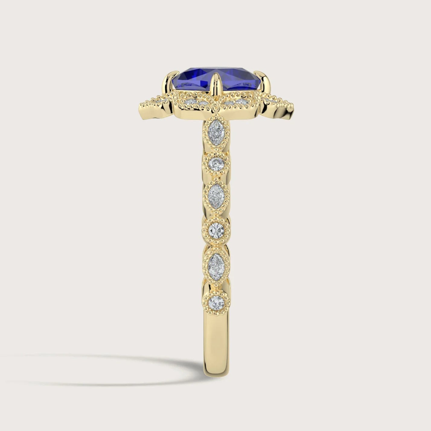 Side view of "lab-grown cushion sapphire" ring, halo setting, diamond gold band.