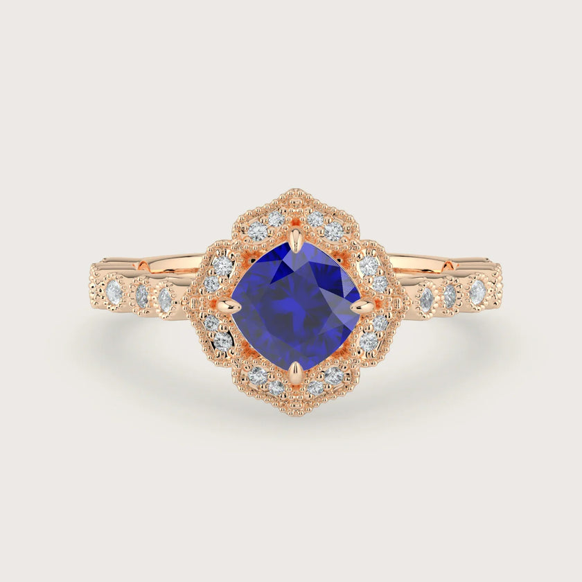 Rose gold engagement ring with cushion-cut lab-grown sapphire and diamond halo.