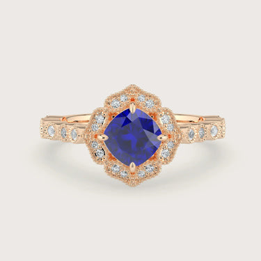 Rose gold engagement ring with cushion-cut lab-grown sapphire and diamond halo.