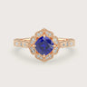 Rose gold engagement ring with cushion-cut lab-grown sapphire and diamond halo.