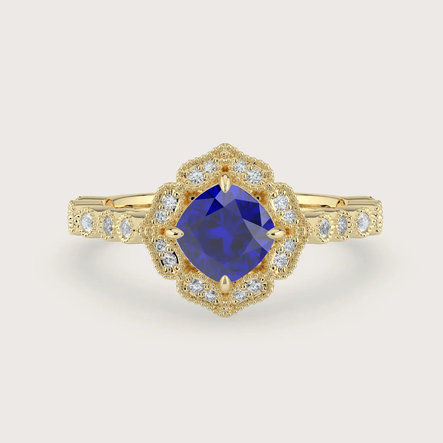 Lab-grown" cushion sapphire engagement ring. Diamond halo, 18k yellow gold band, vintage-inspired design.