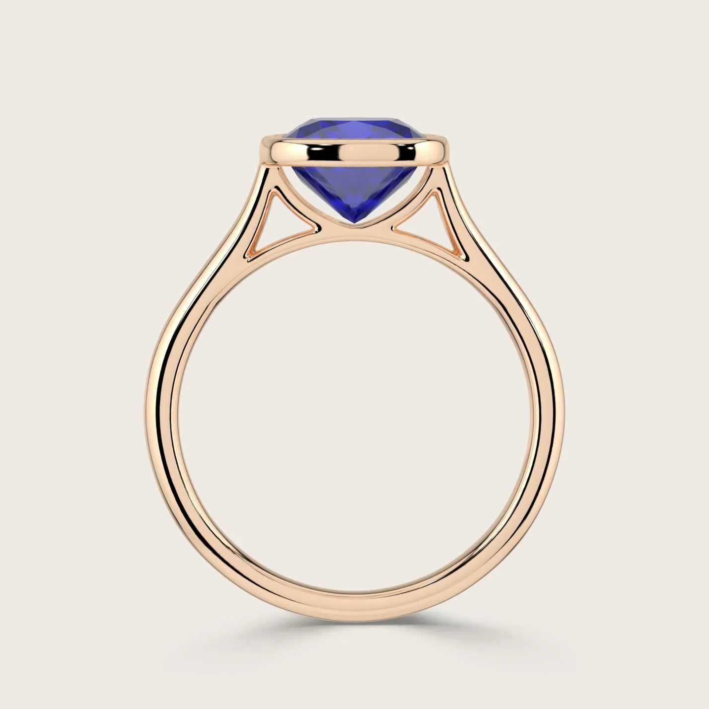 Cushion cut lab-grown sapphire solitaire ring. Bezel set in 18k rose gold.