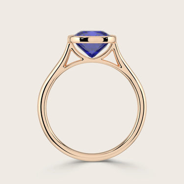 Cushion cut lab-grown sapphire solitaire ring. Bezel set in 18k rose gold.