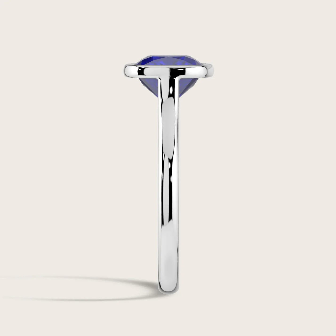 Side view of "R25201CU" lab-grown cushion sapphire solitaire ring in an 18k white gold bezel setting.