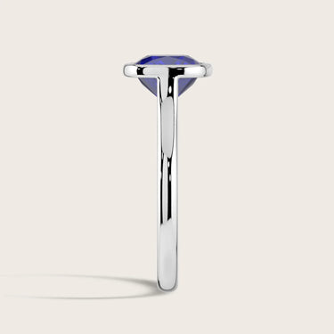 Side view of "R25201CU" lab-grown cushion sapphire solitaire ring in an 18k white gold bezel setting.