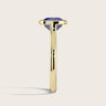 Side view: Lab-grown cushion sapphire solitaire ring, bezel set in 18k yellow gold.