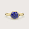 Lab-grown" cushion sapphire solitaire engagement ring in 18k yellow gold, bezel setting.