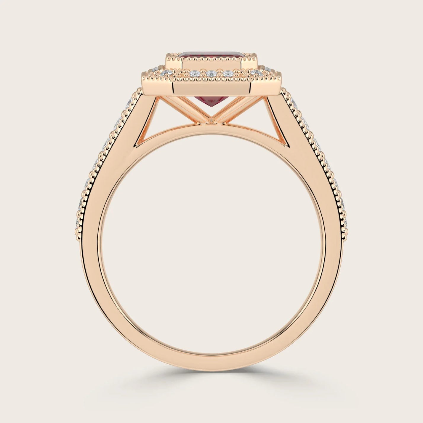 Rose gold ring with "lab-grown emerald", ruby halo, milgrain detail, and vintage diamond band.