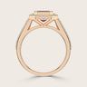 Rose gold ring with "lab-grown emerald", ruby halo, milgrain detail, and vintage diamond band.