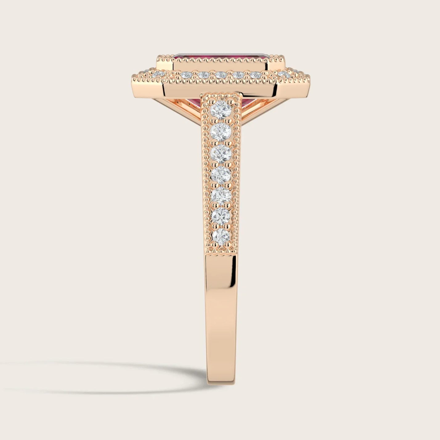 Side view of "lab-grown emerald ruby" ring in 18k rose gold with diamond halo and milgrain vintage band.
