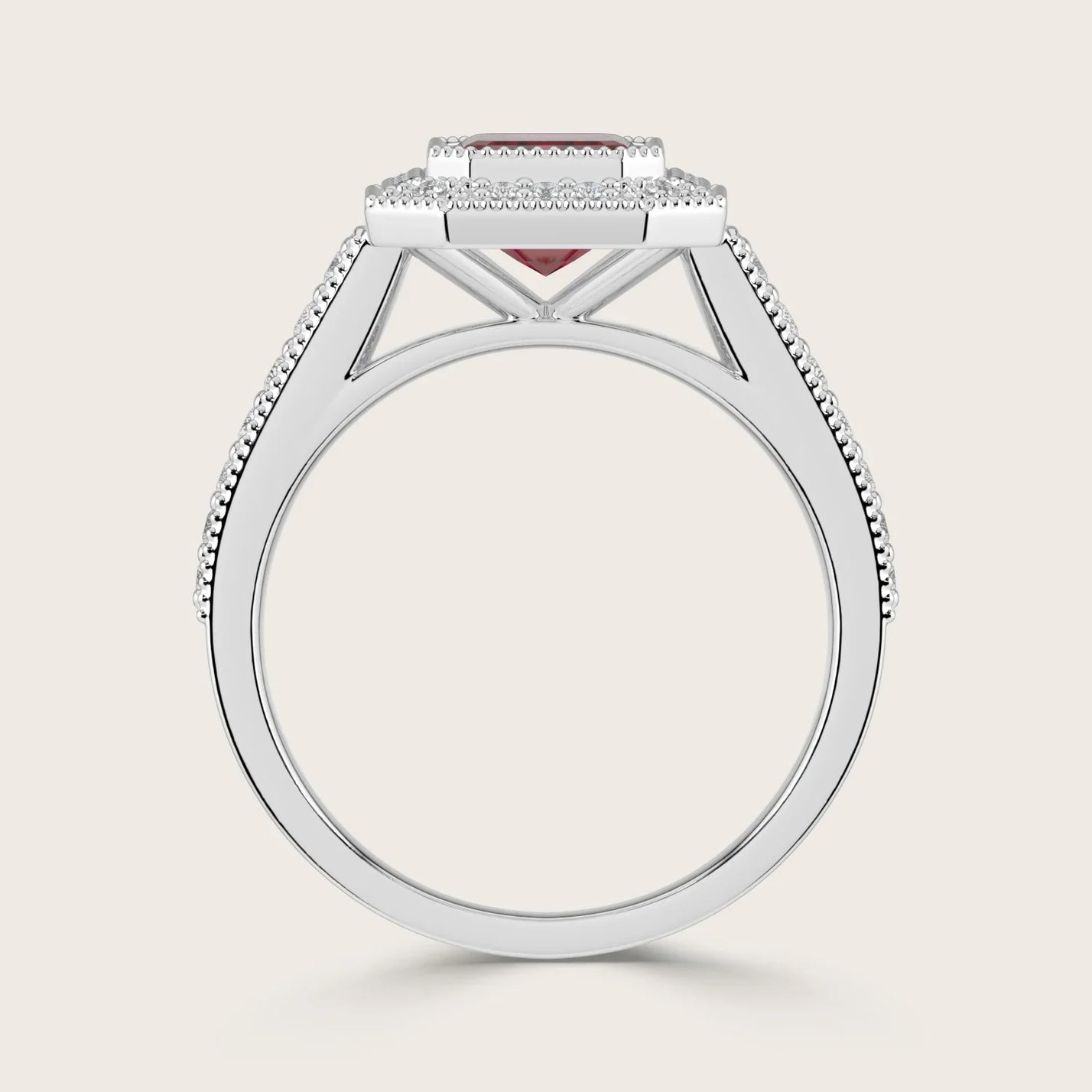Side view of "lab-grown emerald ruby" ring. White gold band with diamond halo and milgrain detail. Vintage style.