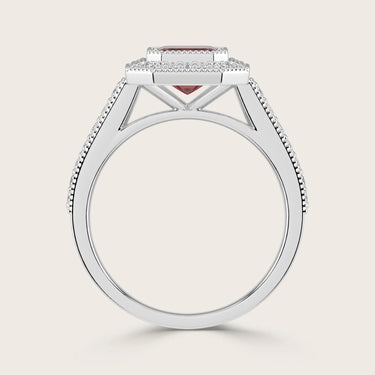 Side view of "lab-grown emerald ruby" ring. White gold band with diamond halo and milgrain detail. Vintage style.