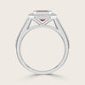 Side view of "lab-grown emerald ruby" ring. White gold band with diamond halo and milgrain detail. Vintage style.