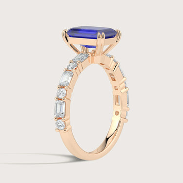 Rose gold ring with lab-grown sapphire center stone and diamond band. "R24831EMA" detail.