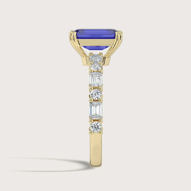 Lab-grown sapphire ring in 18k yellow gold, "R24831EMA," with diamond accents. Side view.