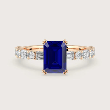 Lab Grown" sapphire engagement ring. Emerald cut stone, diamond band, 18k rose gold setting.