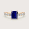 Lab Grown" sapphire engagement ring. Emerald cut stone, diamond band, 18k rose gold setting.