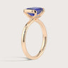 Rose gold "half bezel" ring with lab-grown sapphire solitaire and accent diamonds.