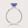 Close-up of a lab-grown sapphire solitaire ring with half bezel in 18k white gold.