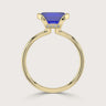 Lab-grown emerald-cut sapphire solitaire ring in 18k yellow gold with "half bezel" setting.