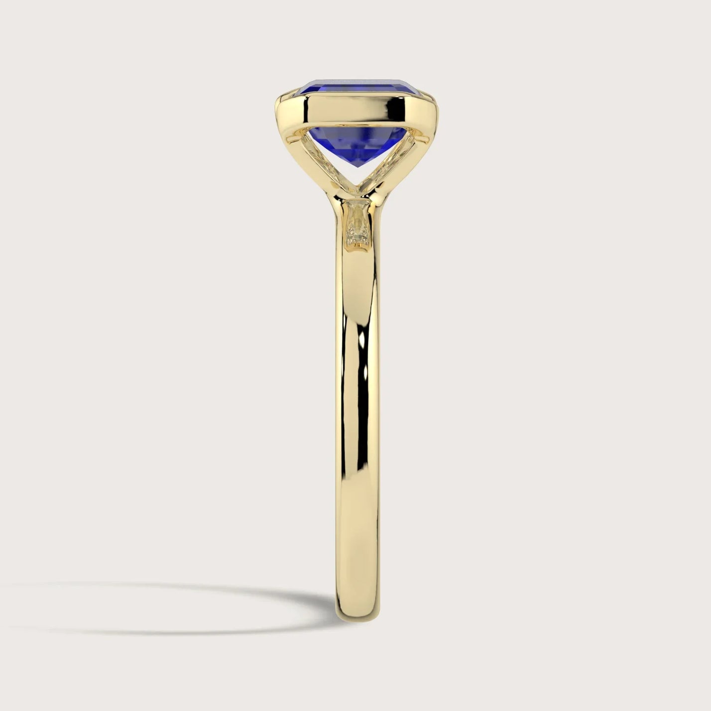 Lab-grown sapphire solitaire ring. Half bezel setting, 18k yellow gold band. "R25201EM" model.