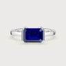 R25201EM" solitaire ring: lab-grown emerald-cut sapphire in 18k white gold half-bezel setting.