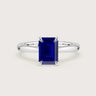 Lab-grown emerald-cut sapphire solitaire ring in 18k white gold with hidden halo. "R24819EMH" style.