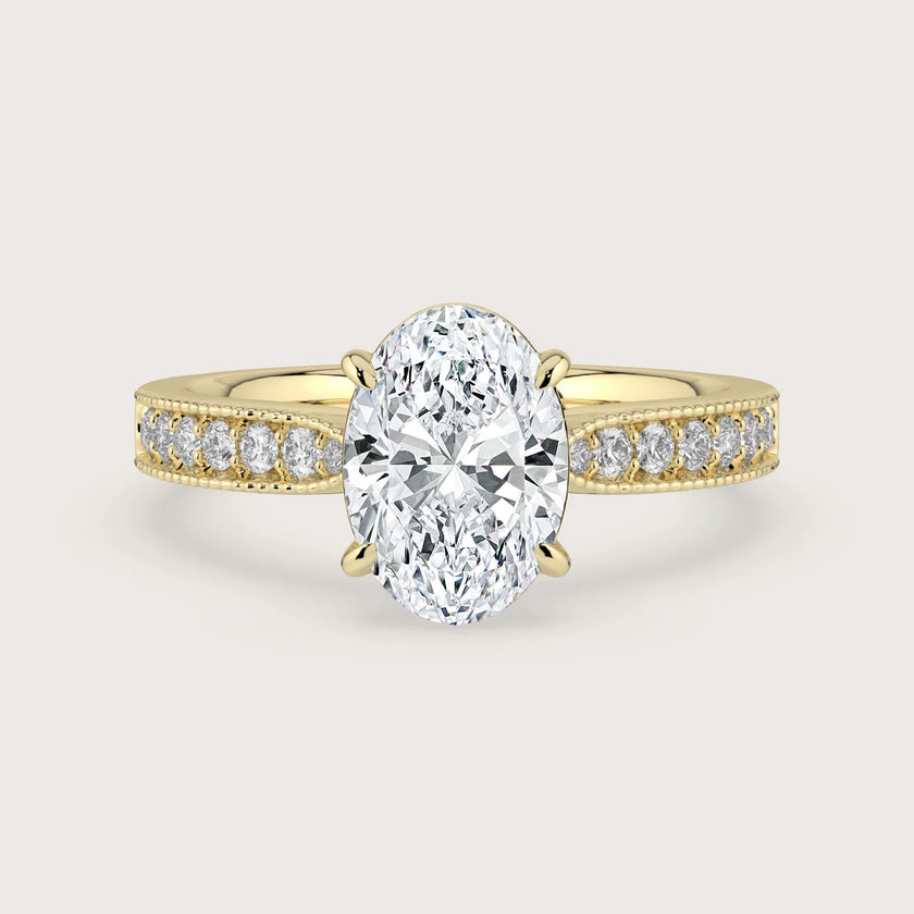 Oval lab-grown diamond engagement ring. 18k yellow gold band with milgrain detail. "R24821OVA" style.