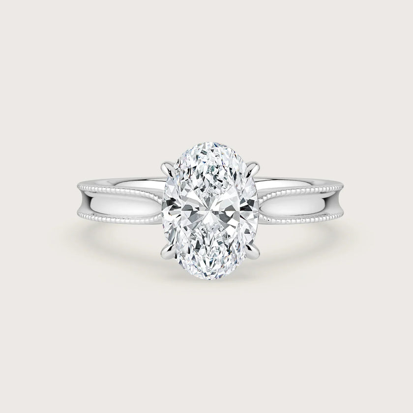 Oval lab-grown diamond solitaire engagement ring in 18k white gold with milgrain detailing. "R24821OV.