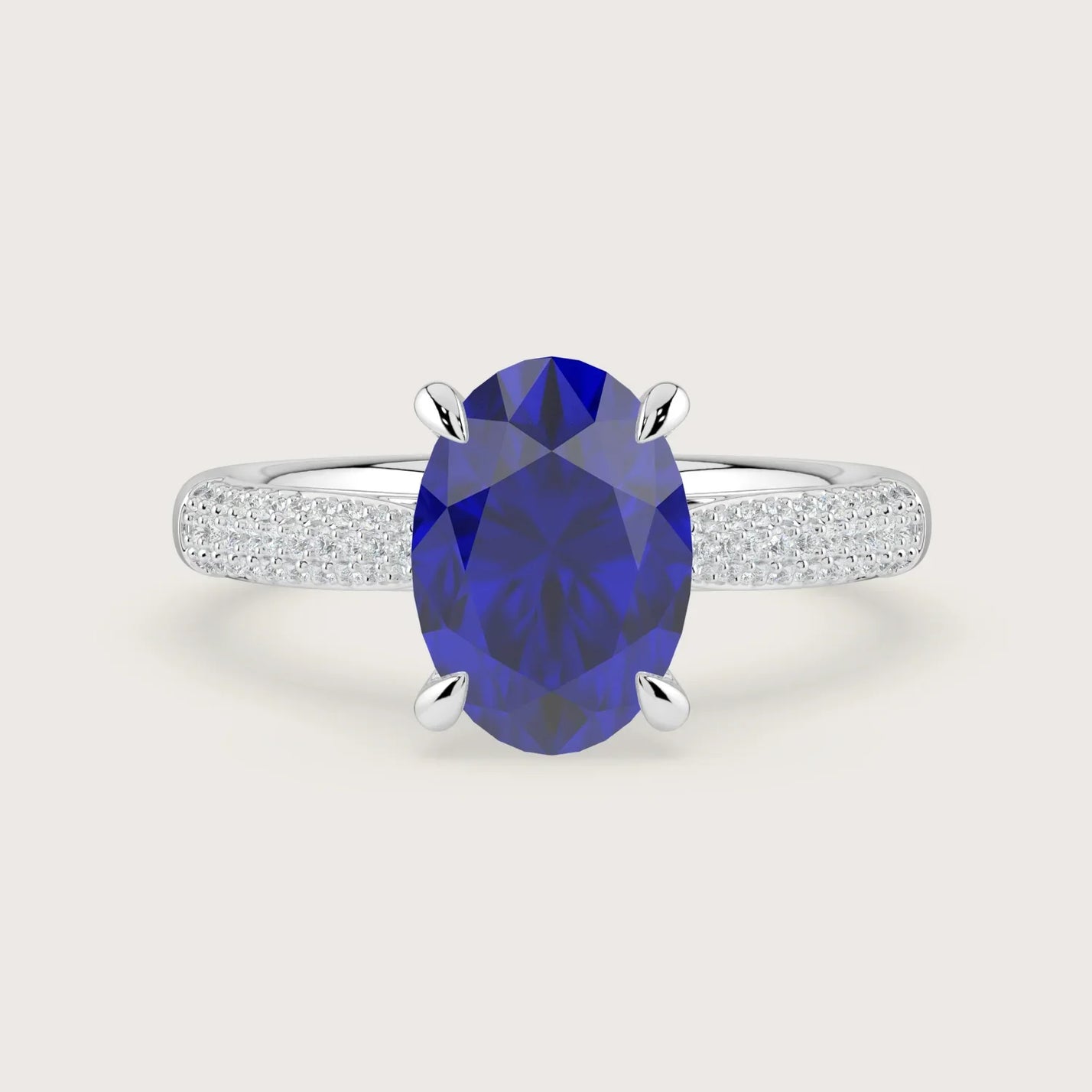 Oval lab-grown sapphire engagement ring with diamond band and "hidden halo" in 18k white gold.