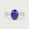 Oval lab-grown sapphire engagement ring with diamond band and "hidden halo" in 18k white gold.