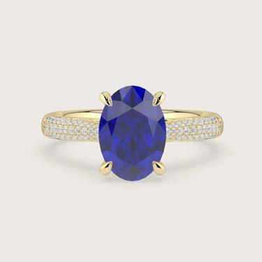 Oval lab-grown sapphire engagement ring. 18k yellow gold band with diamond accents. "R24827OVA.